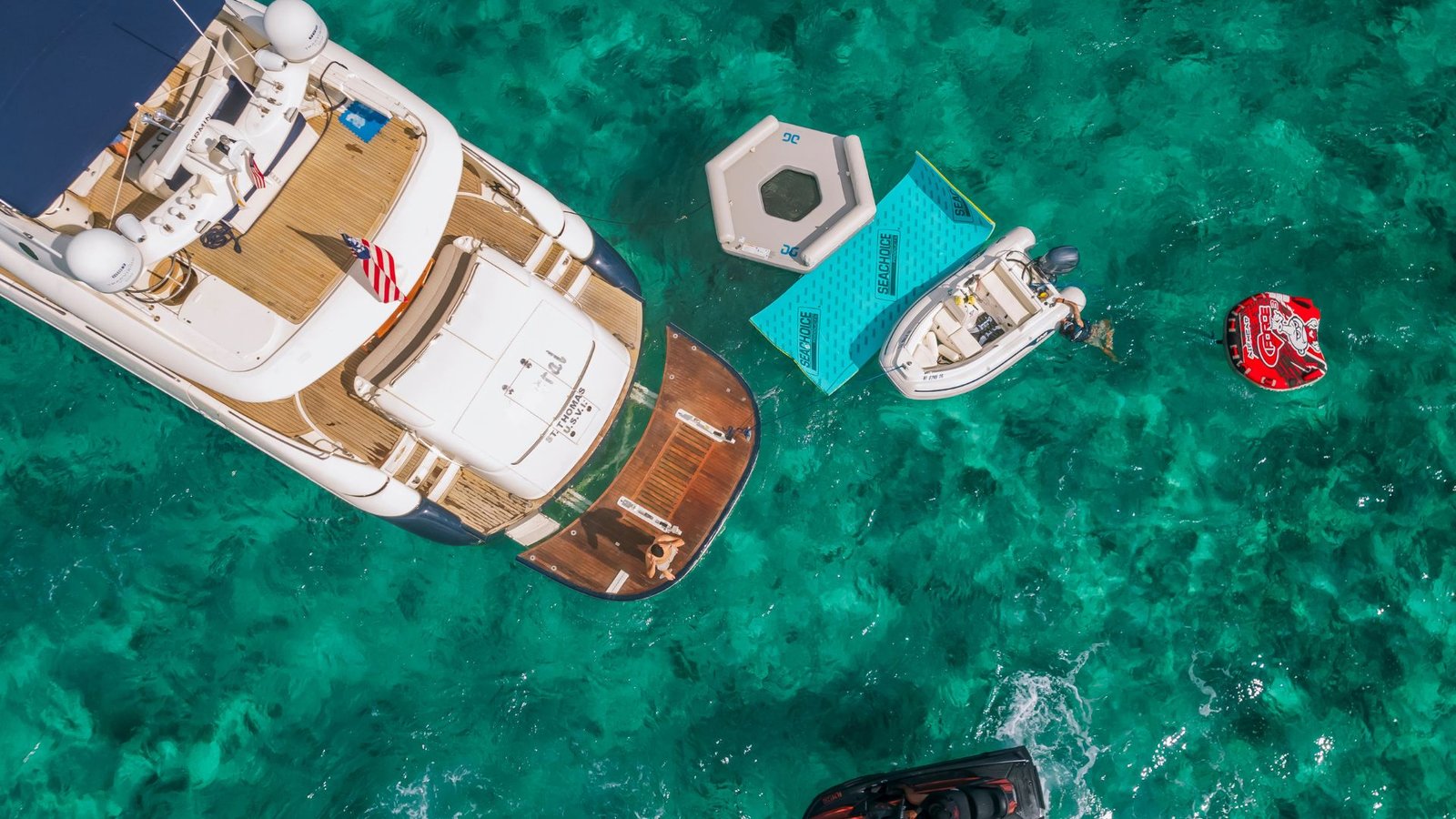 Aerial view of a yacht anchored with floats on turquoise water near Miami