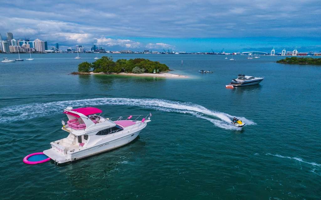 Flybridge yacht with a jet ski on Biscayne Bay