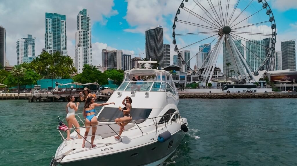 Guests on the bow of the Remedy 50' by the Bayside Ferris wheel, Miami