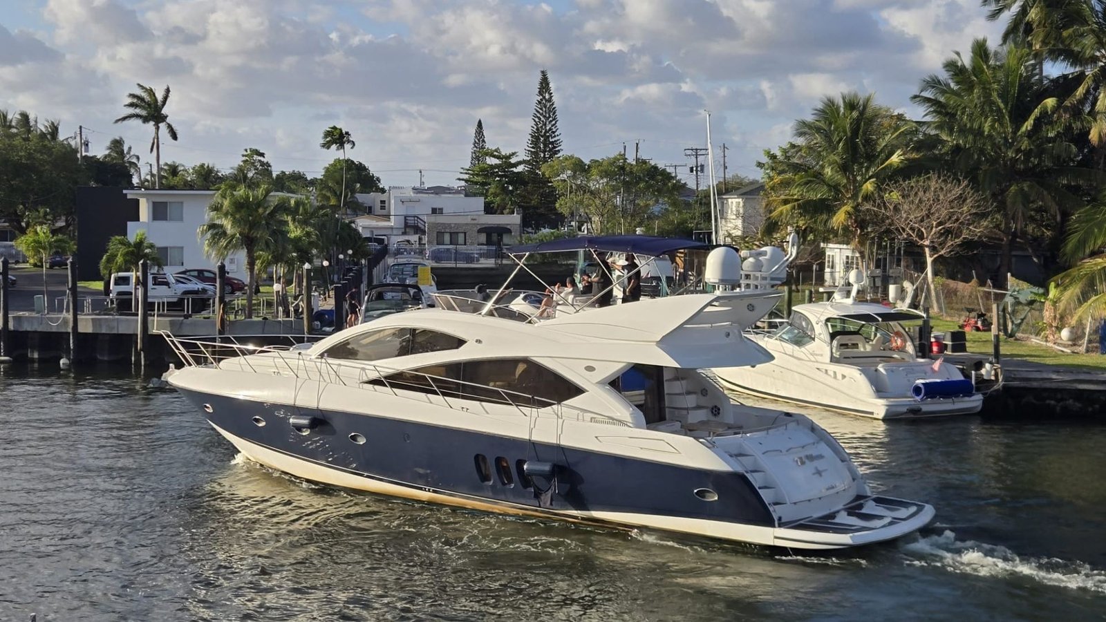 Sunseeker 70' Money Waves cruising a palm-lined Miami canal