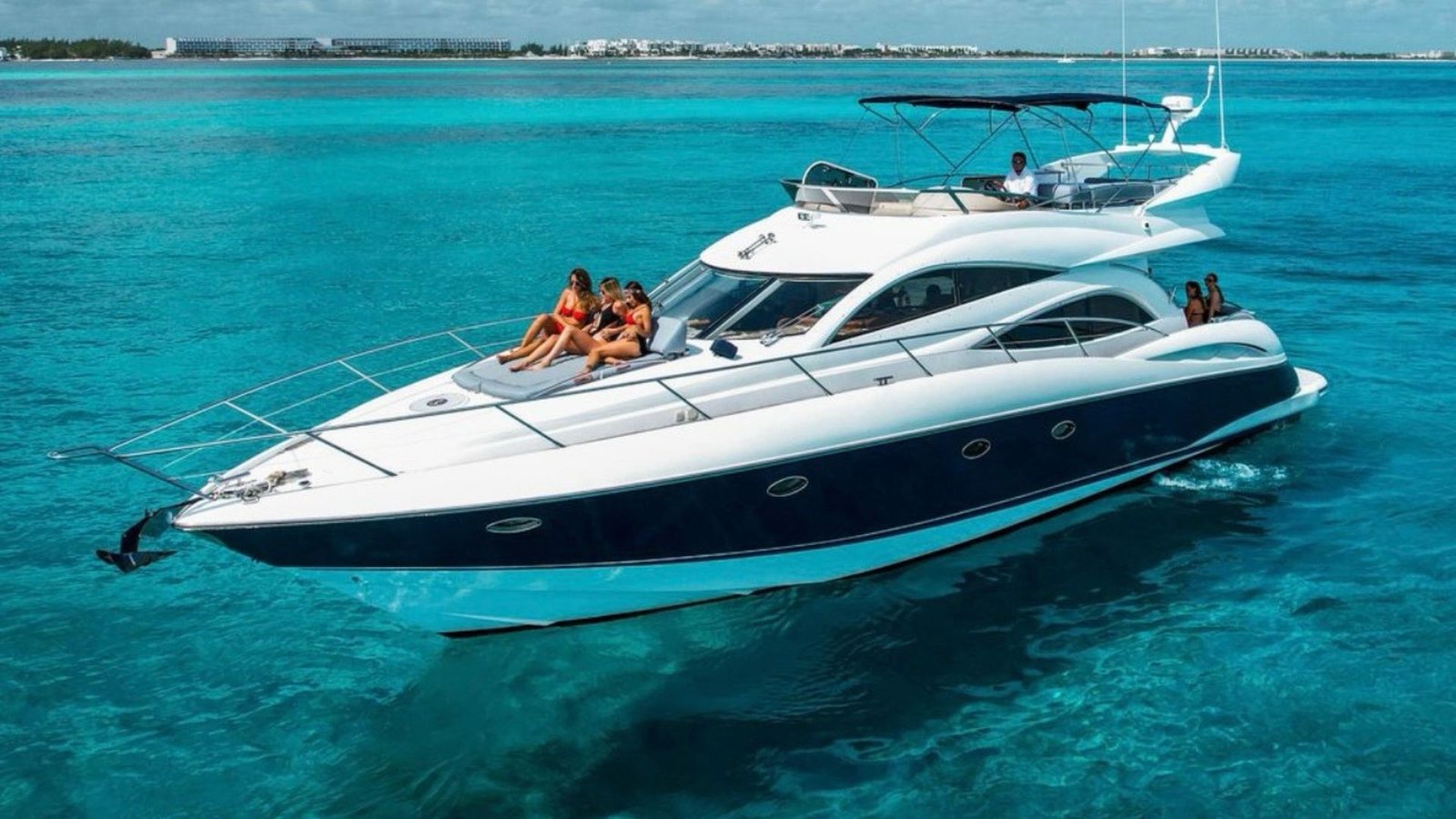 Sunseeker 70' Money Waves with guests on turquoise water in Miami