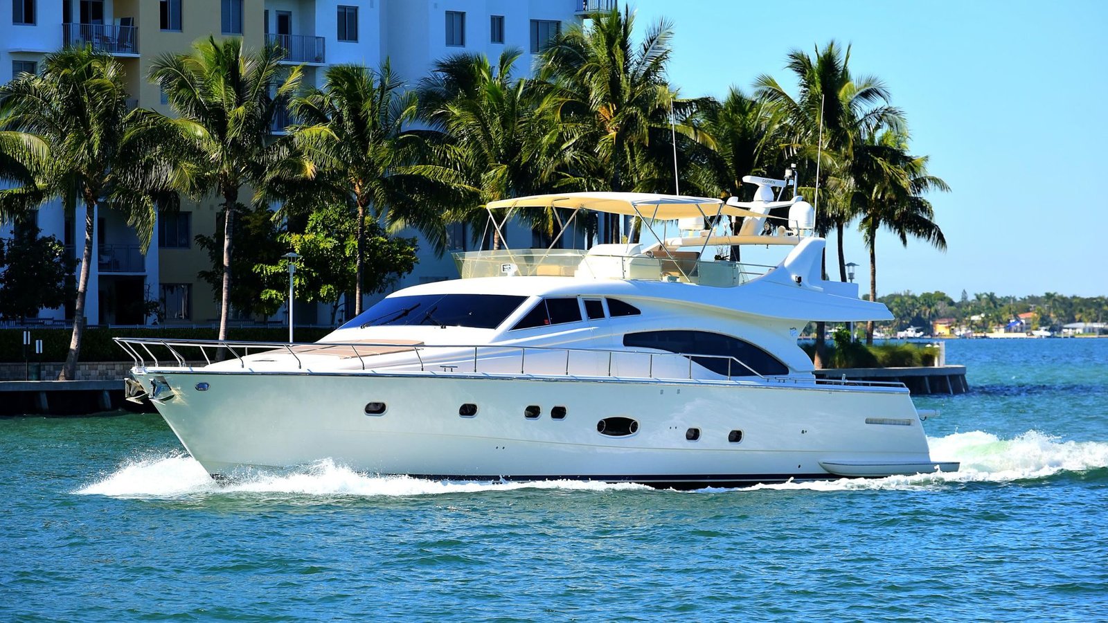80' Ferretti yacht Lumar cruising past palm-lined waterfront in Miami